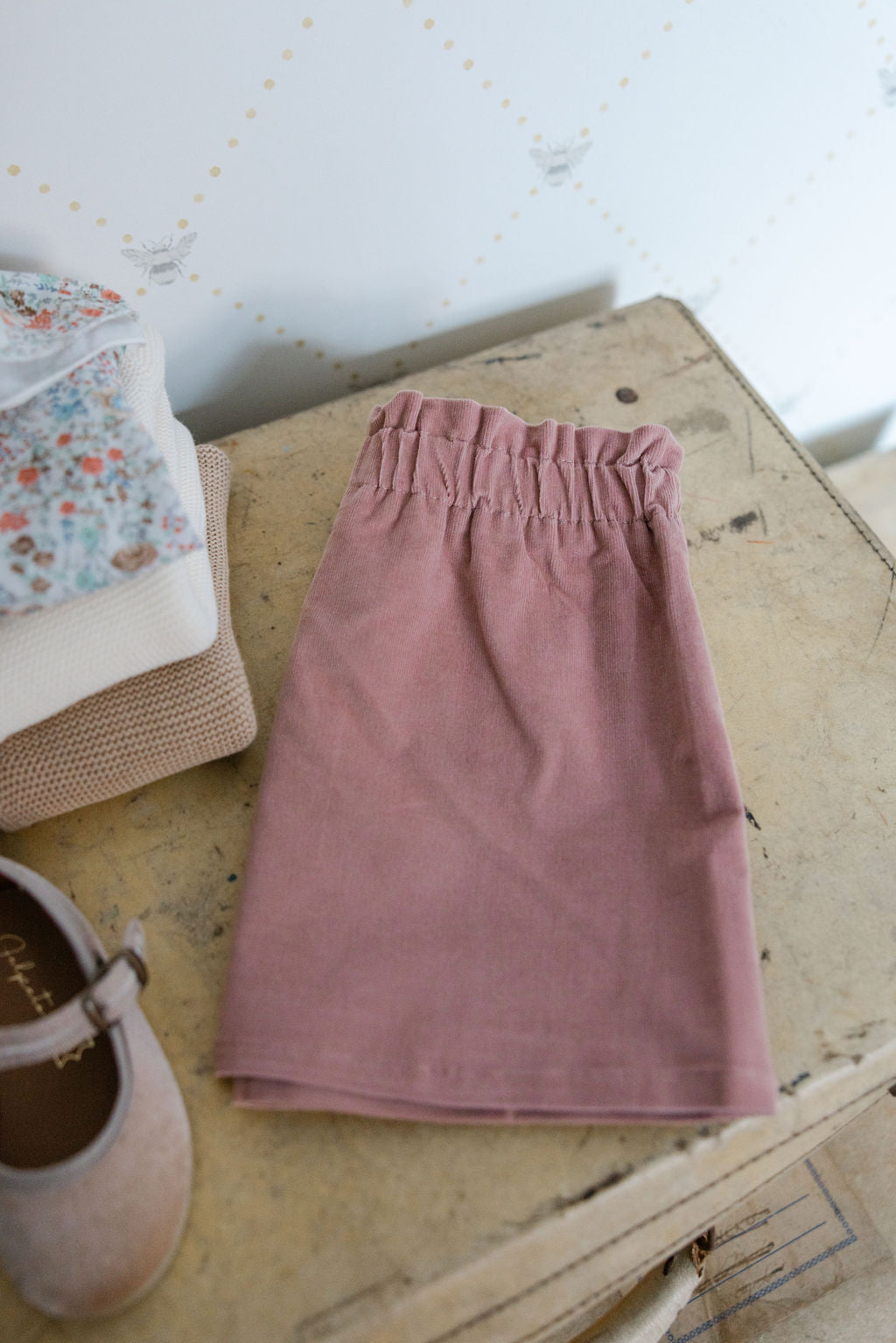 Pink skirt on a wooden surface with a white background