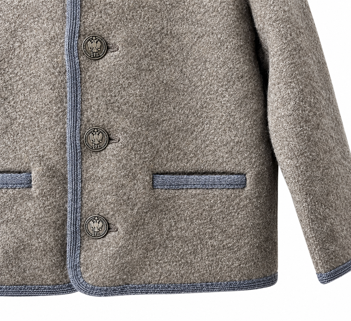 Close-up of a textured gray wool-blend jacket with blue-gray contrast piping and three dark metal buttons featuring a crest emblem.