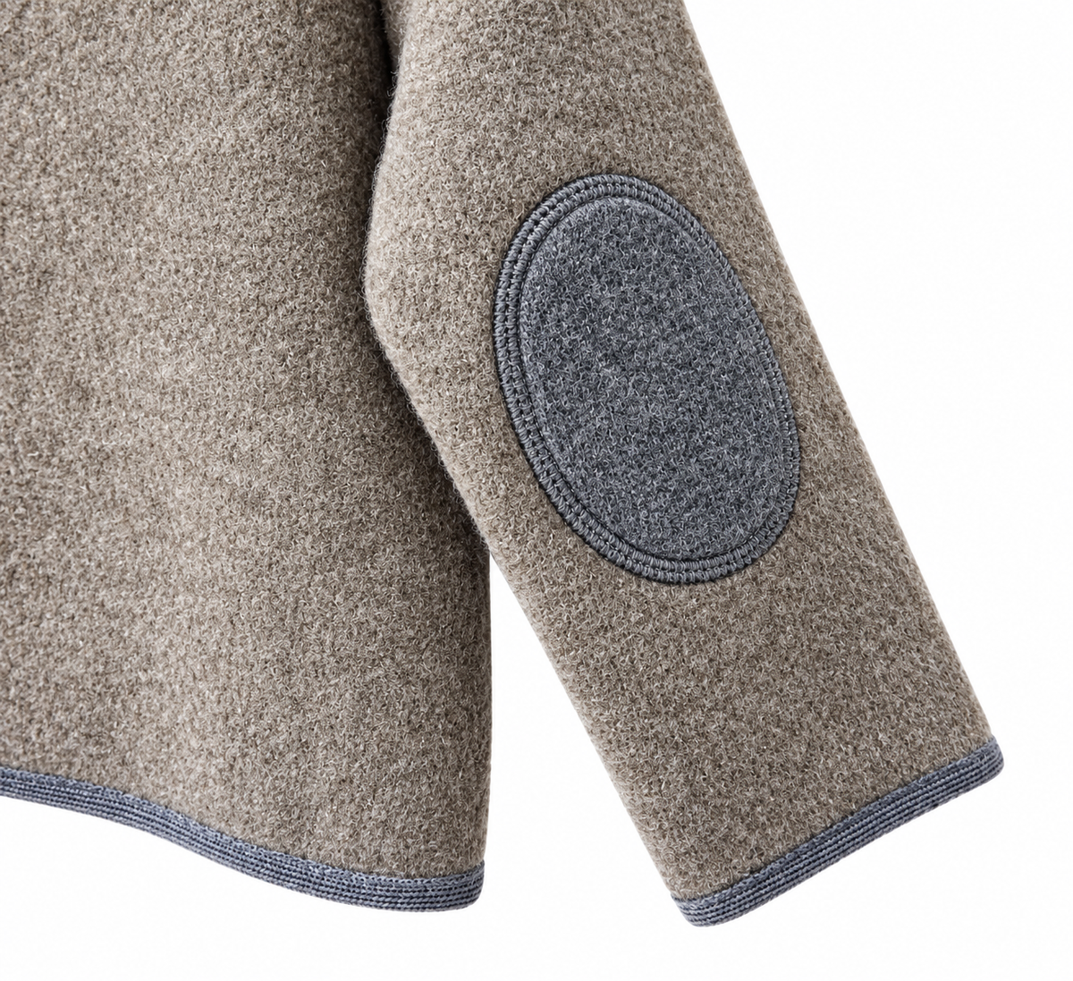 Close-up of a textured taupe wool-blend jacket sleeve with a circular dark gray patch on the elbow and a blue-gray ribbed hem, shown on a white background.